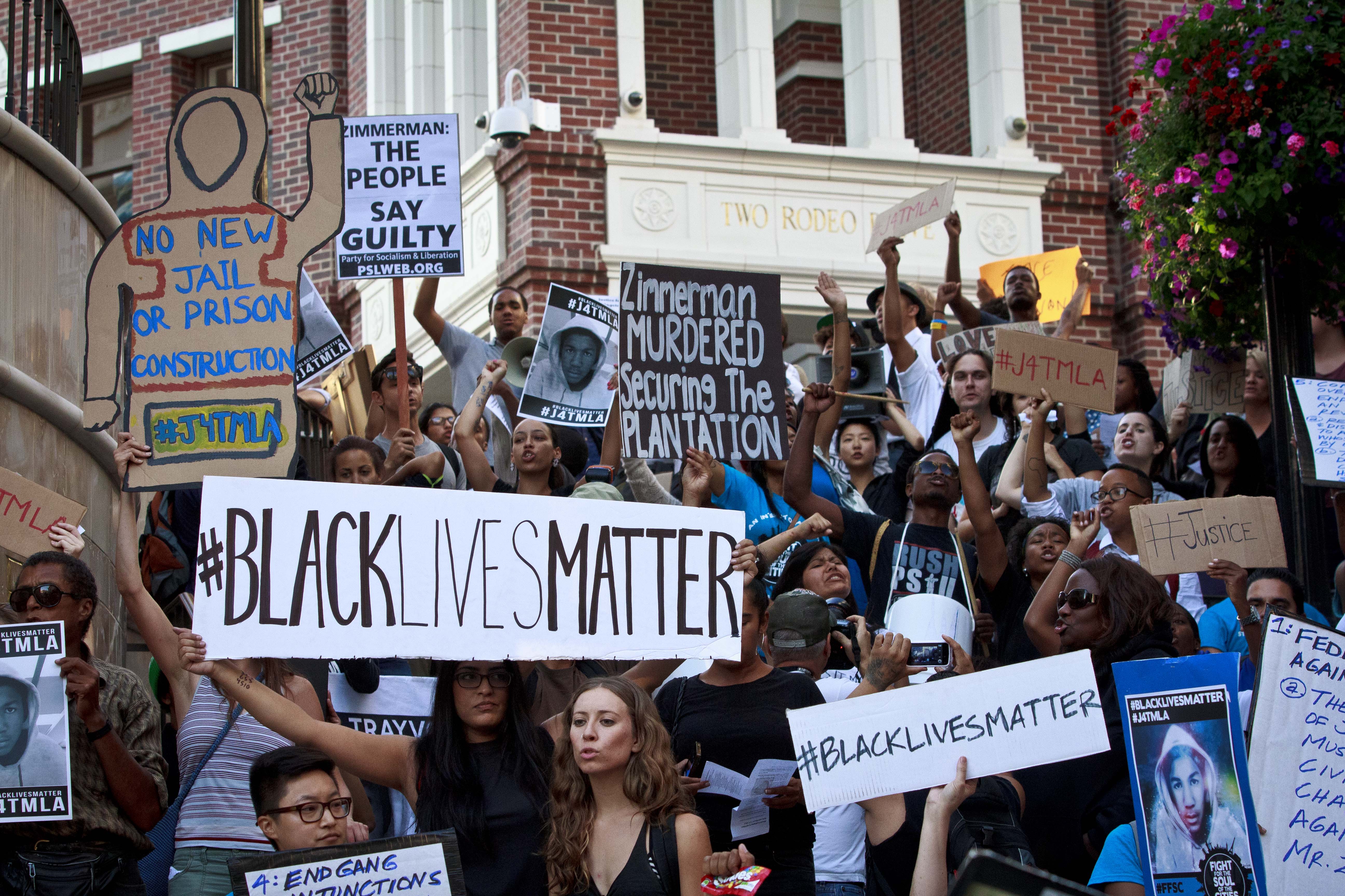 Protesters take to the streets to bring attention to the push for justice in the Trayvon Martin case as they take over Rodeo Drive on July 17, 2013 in Beverly Hills, California. (Photo by Jose Lopez)